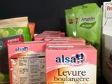 several boxes of food are sitting on a counter next to a bag of bread