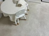 a little girl that is sitting at a table