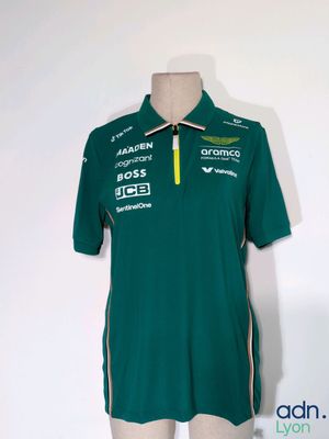 the shirt is green and white with a yellow zipper on the collar