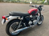 a red and black motorcycle parked in a parking lot