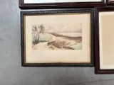 three framed pictures on the wall of a bathroom