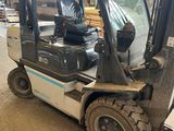 a forklift truck that is parked in a warehouse