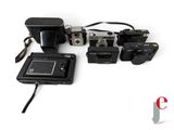 a small camera and some other electronics on a white surface