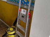 a ladder leaning against a wall with graffiti on the wall