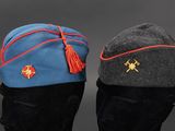 two hats with a tassel on top of them sitting on top of a table