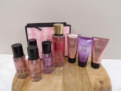 the contents of a cosmetic bag are sitting on a wooden table