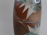 a brown vase with blue and white designs on it