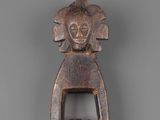 a close up of a wooden object with a bird on it