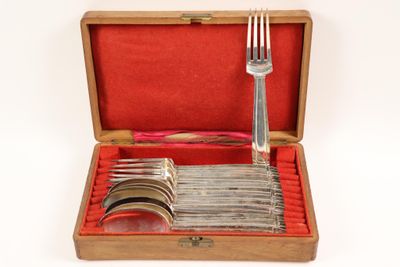 a wooden box with silverware in it and a fork in it