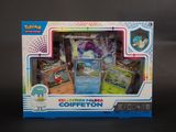 La boîte contient un lot de cartes Pokémon et une manette de jeu.