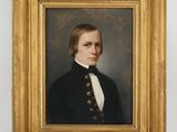 portrait of a young man in a black coat and white shirt