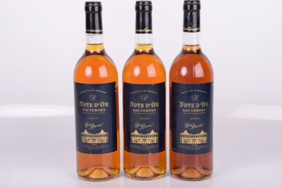 three bottles of wine sitting next to each other on a white surface
