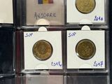 six different types of coins in a display case