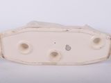 a white object with holes in it on a white surface