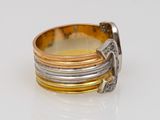 an image of a gold and silver ring on a white surface