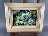 an oil painting of flowers in a wooden frame on a easel