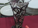 a glass vase sitting on top of a red table cloth