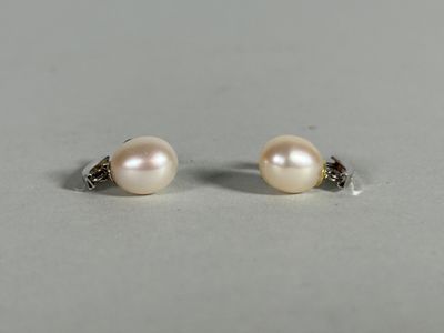 a pair of pearl and diamond stud earrings