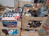 two boxes filled with shoes and clothes on the floor