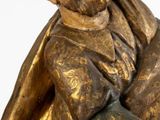 a statue of a man holding a dog in his arms