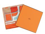 a box with an orange and blue scarf inside of it