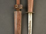 two knives are laying side by side on a black surface