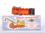 a toy truck with a crane sitting on top of it