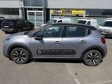 La petite voiture est garée sur le parking situé à l'extérieur du bâtiment.