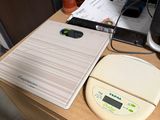 a laptop and a printer sitting on a desk next to a cell phone