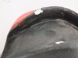 a close up of a black and red boat on the water