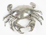 a silver crab that is sitting on a white surface