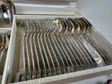 a lot of silver spoons and spoons in a box
