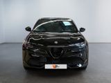 the front view of a black car parked in a showroom