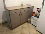 a small kitchen with a refrigerator and a small counter