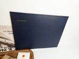a wooden tray with books and a laptop on it
