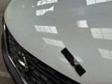 a close up of a white car with a sticker on it