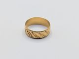 a close up of a gold ring on a white surface