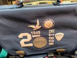 a bag that has some badges on it