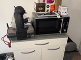 a microwave and a coffee maker sitting on top of a kitchen counter