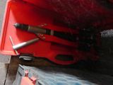 a red case with tools in it sitting on a table