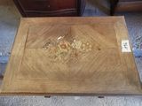 une petite table en bois ornée d'un motif floral