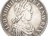 a close up of a silver coin with a woman ' s head on it