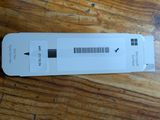 a white box with a barcode on it sitting on a wooden table