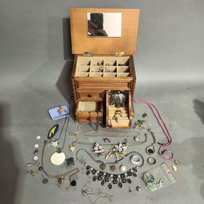 a small wooden jewelry box with a mirror on top of it