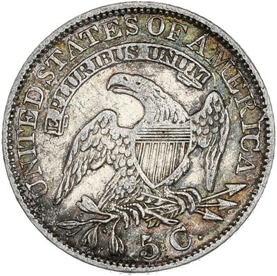 une pièce d'argent sur laquelle est représenté un aigle