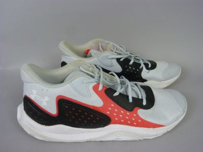 a pair of white and black sneakers with red accents on them
