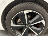 a close up of a tire on a white car