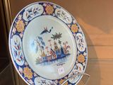a plate that is on display in a glass case
