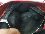 the inside of a red purse with a zipper on it