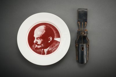 a plate with a picture of a man on it next to a knife